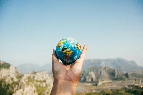 photo of a hand carrying the earth